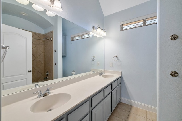 bathroom featuring tile patterned flooring, vanity, and tiled shower