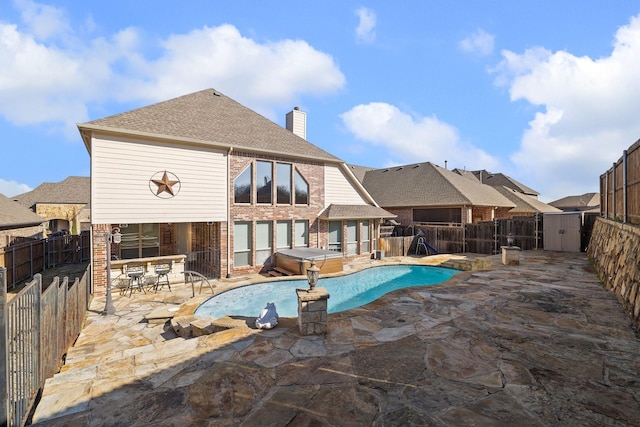 view of swimming pool with a hot tub and a patio