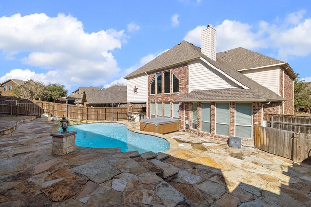 view of pool featuring a hot tub and a patio