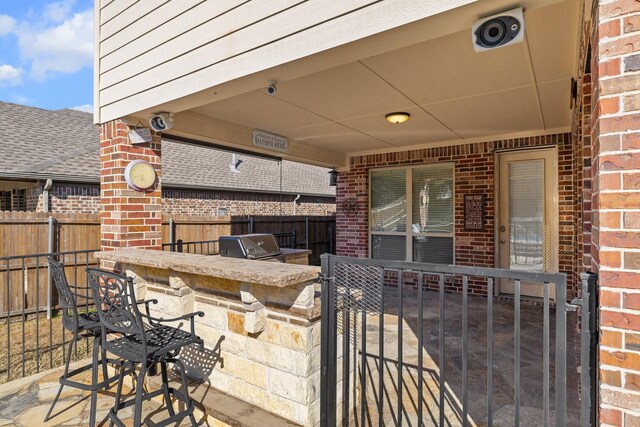 view of patio with a fenced in pool and area for grilling