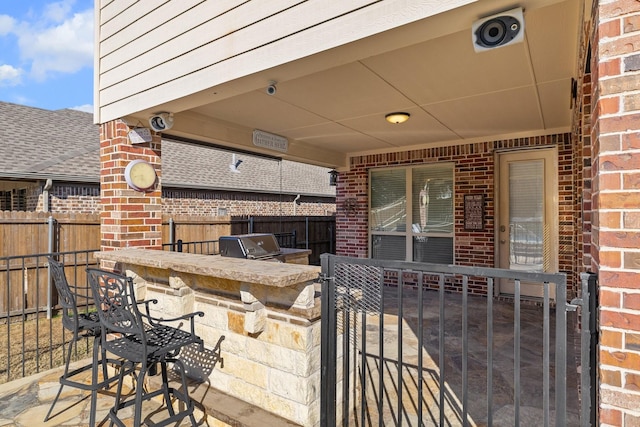 view of patio featuring a bar and an outdoor kitchen