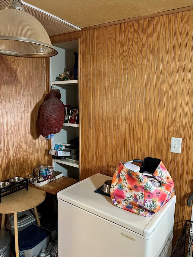 washroom featuring washer / dryer and wood walls