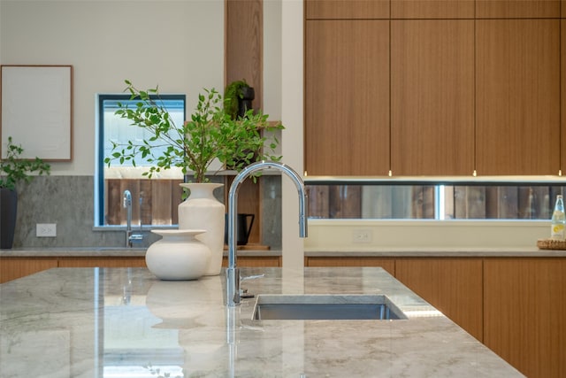 room details featuring sink and light stone countertops