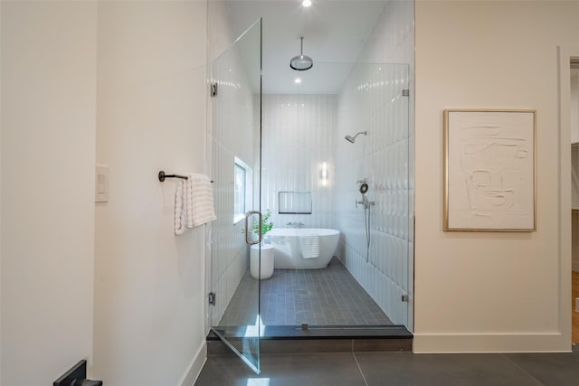 bathroom with independent shower and bath and tile patterned flooring