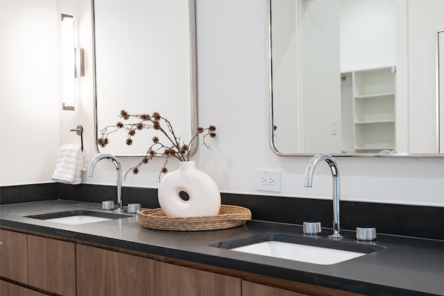 interior space featuring double vanity and a sink