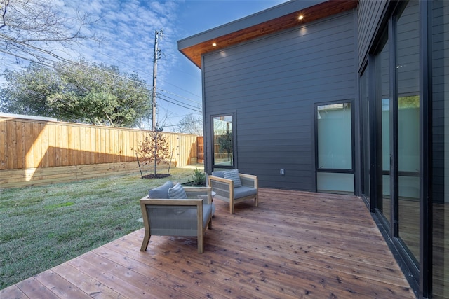 wooden terrace with a yard and an outdoor hangout area