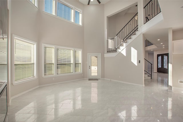 unfurnished living room featuring a high ceiling