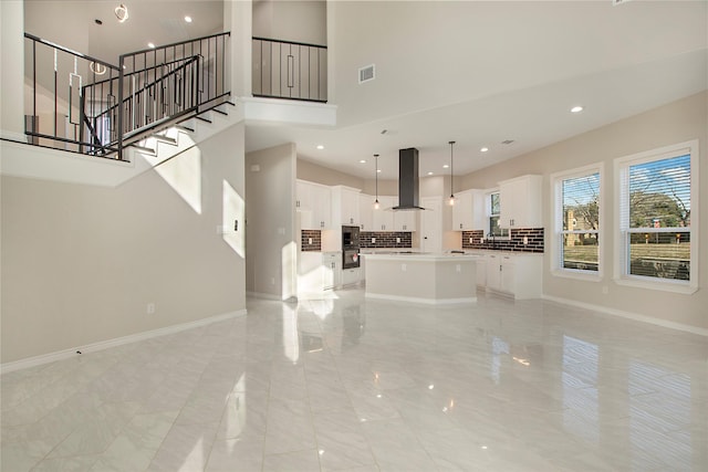 unfurnished living room with a high ceiling