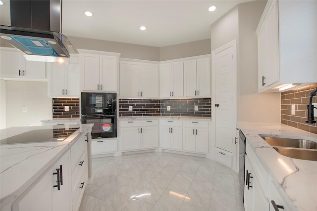 kitchen featuring sink, light stone counters, ventilation hood, white cabinets, and black appliances