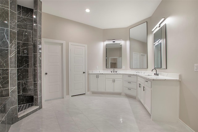 bathroom with vanity and a tile shower