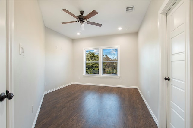 spare room with dark hardwood / wood-style floors and ceiling fan