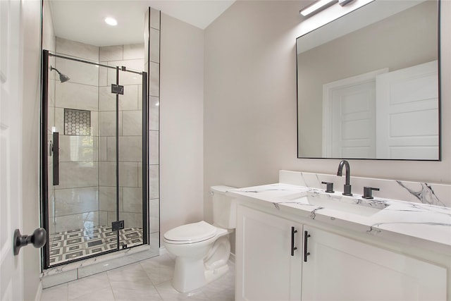 bathroom featuring vanity, toilet, and a shower with door