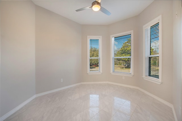 unfurnished room with light tile patterned floors and ceiling fan