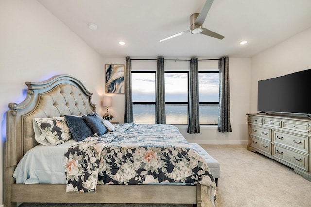 bedroom with light colored carpet and ceiling fan