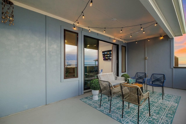 patio terrace at dusk featuring an outdoor hangout area