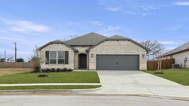 french country home featuring central AC, a front lawn, fence, and brick siding