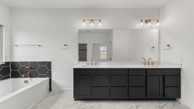 full bathroom featuring double vanity, marble finish floor, a sink, and a bath