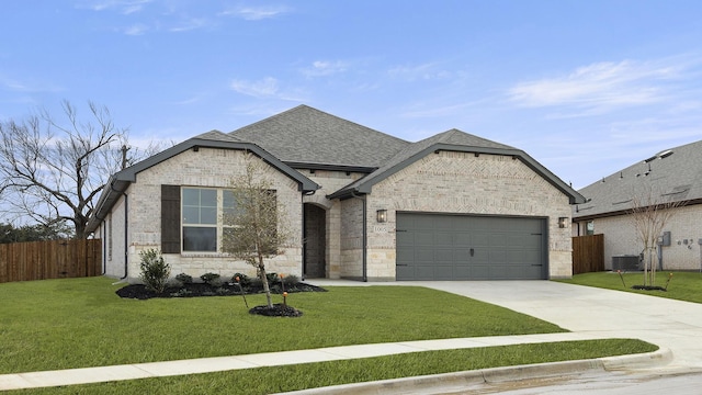 french country inspired facade featuring driveway, roof with shingles, an attached garage, fence, and a front lawn