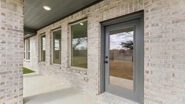 property entrance with brick siding