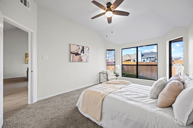 carpeted bedroom with ceiling fan and lofted ceiling