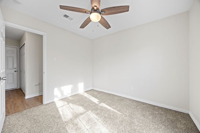 empty room with ceiling fan and carpet