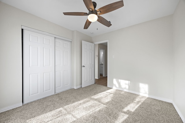 unfurnished bedroom with a closet, ceiling fan, and carpet