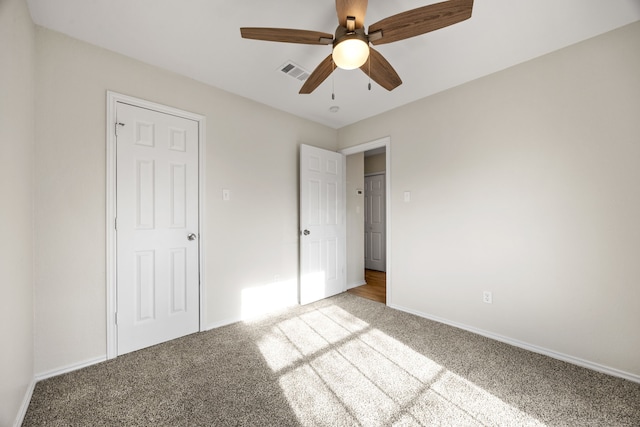 unfurnished bedroom with ceiling fan and light carpet