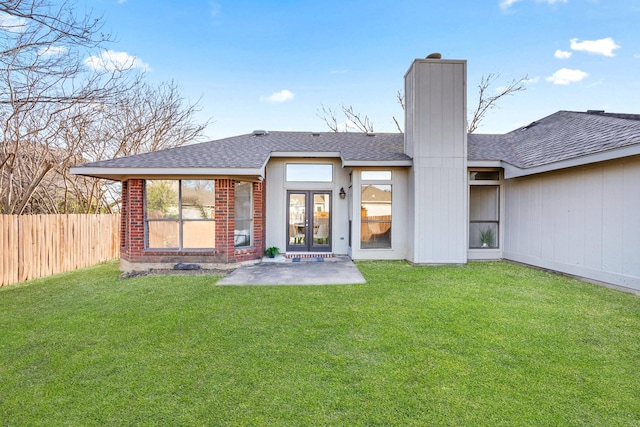 rear view of house featuring french doors and a yard