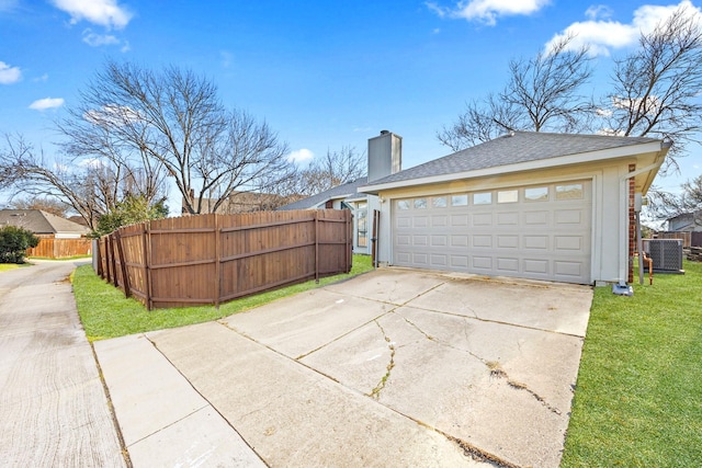 garage with cooling unit and a lawn