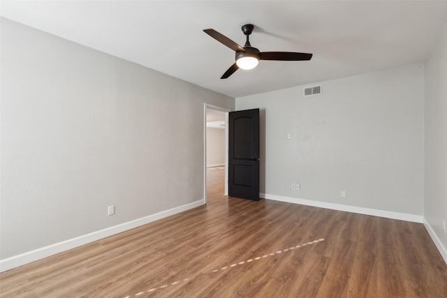 spare room featuring hardwood / wood-style flooring and ceiling fan