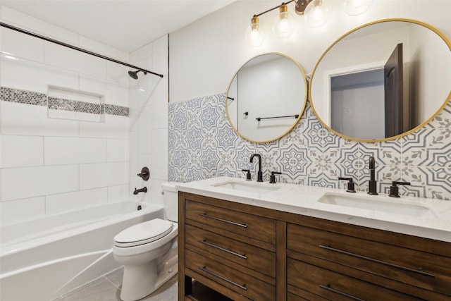 full bathroom with tiled shower / bath, decorative backsplash, tile patterned flooring, vanity, and toilet