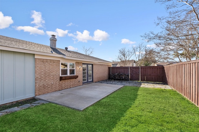 view of yard with a patio area and french doors