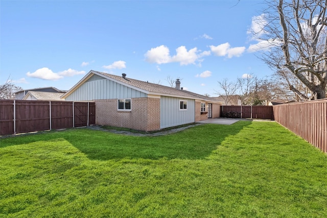 back of property with a yard and a patio area