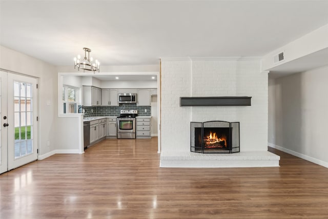 kitchen with dark wood-type flooring, gray cabinets, stainless steel appliances, and french doors