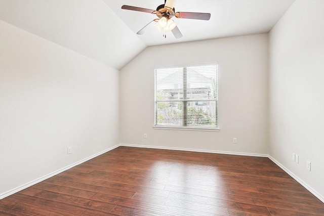 spare room with vaulted ceiling, dark hardwood / wood-style floors, and ceiling fan