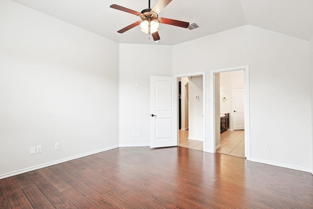 empty room featuring ceiling fan, lofted ceiling, and light hardwood / wood-style floors