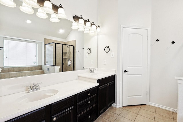 bathroom featuring tile patterned flooring, vanity, a shower with shower door, and lofted ceiling