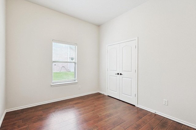 unfurnished room featuring dark hardwood / wood-style flooring