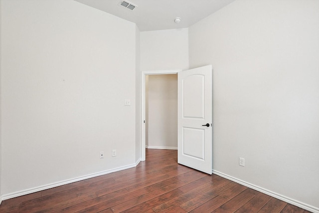 unfurnished room with dark hardwood / wood-style flooring