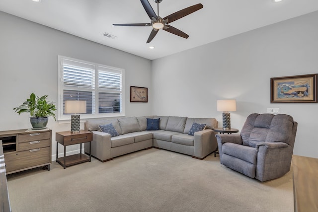 living room with light colored carpet and ceiling fan