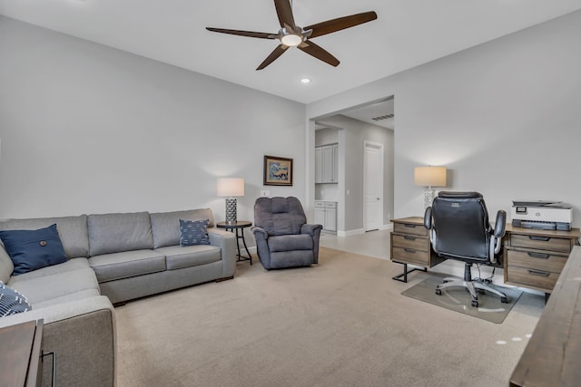 home office with light carpet and ceiling fan