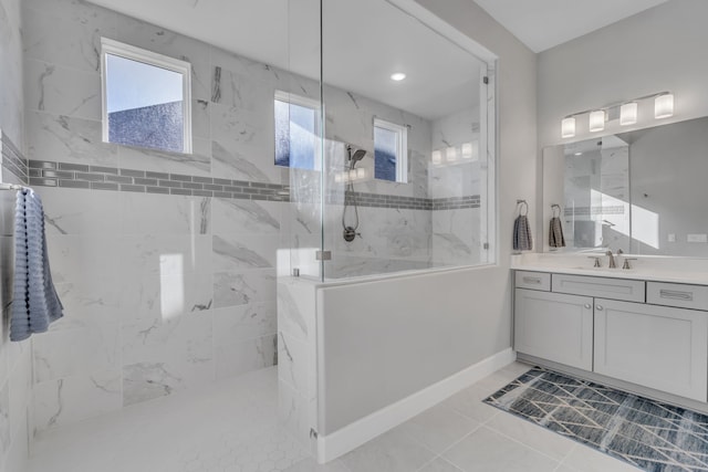 bathroom featuring vanity and tiled shower