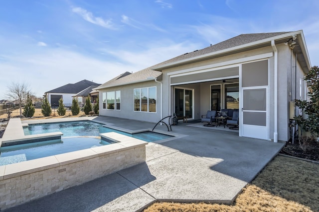 view of swimming pool featuring an in ground hot tub and a patio