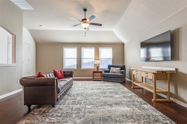 living room featuring dark wood-type flooring, vaulted ceiling, and ceiling fan