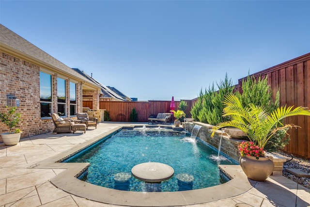 view of pool with pool water feature and a patio