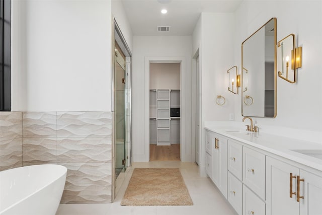 bathroom featuring vanity and independent shower and bath