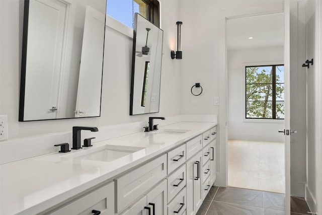 bathroom with tile patterned floors and vanity