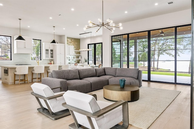 living room featuring a chandelier and light hardwood / wood-style floors