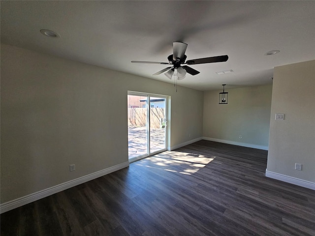 unfurnished room with dark hardwood / wood-style floors and ceiling fan