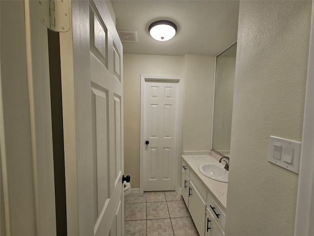 bathroom with vanity and tile patterned flooring